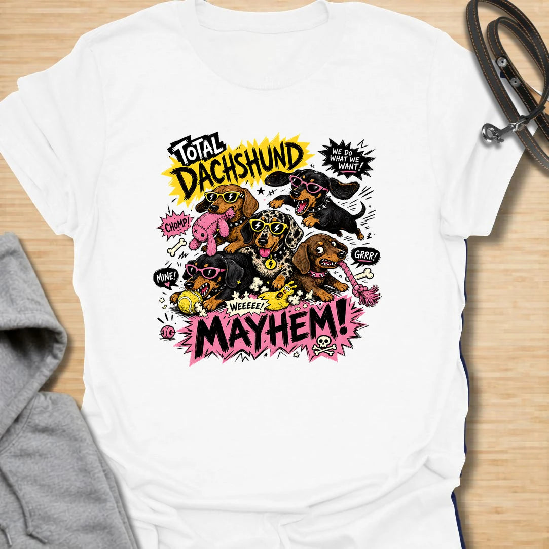 Dachshund Mayhem t-shirt for doxie lovers who live with tiny chaos, loud opinions, and nonstop sausage dog energy. This bold comic-style design features a wild pack of dachshunds causing total mayhem with toys, sunglasses, and attitude. Perfect for dachshund moms, multi-dog homes, and anyone who loves loud, funny dog designs.