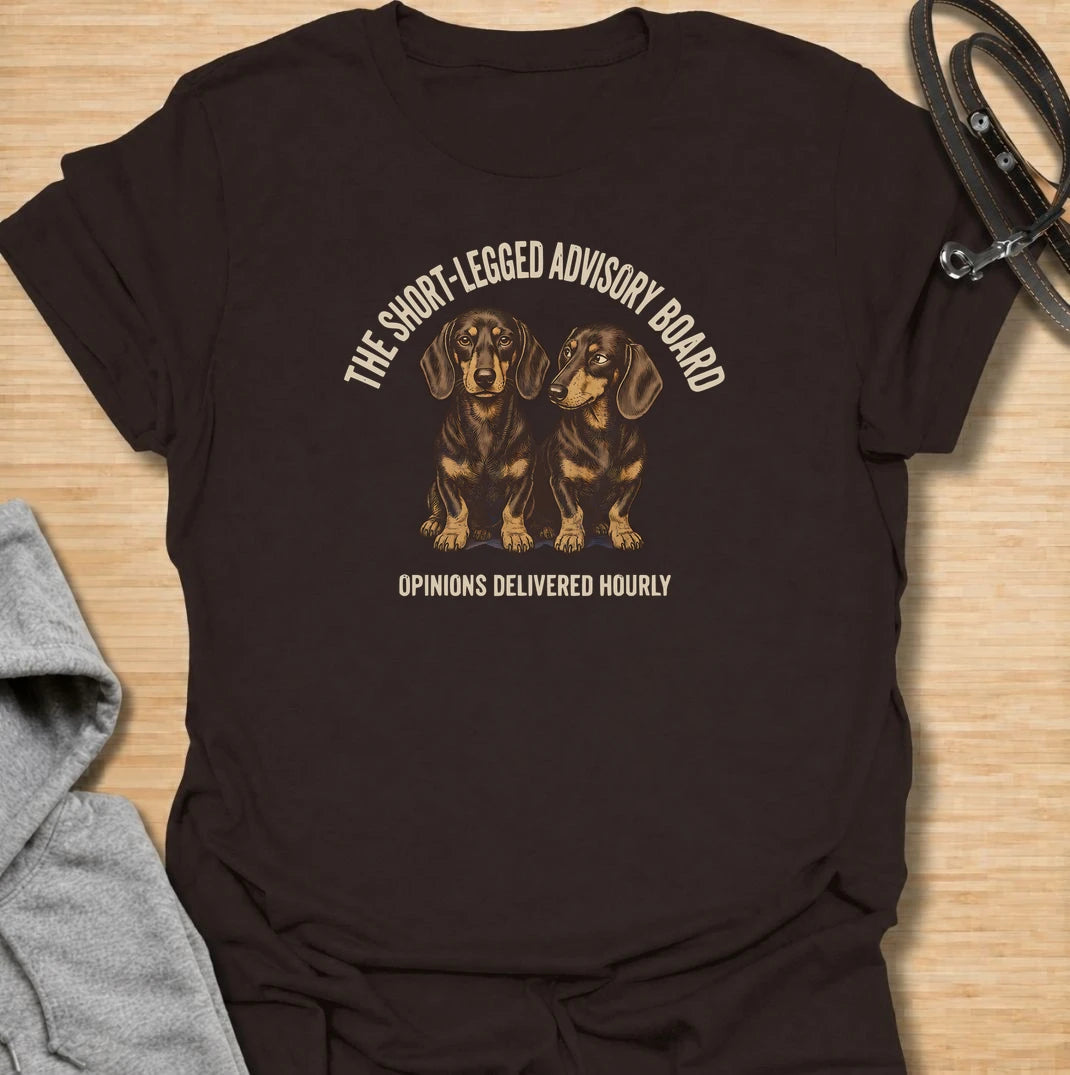 For dachshund owners who never have to wonder what their dogs think — because the opinions arrive all day long. This funny dachshund T-shirt features “The Short-Legged Advisory Board” with the line “Opinions Delivered Hourly” and two wonderfully serious doxies. Perfect for anyone who shares their home with small dogs, big personalities and absolutely no shortage of commentary. A fun vintage-style dachshund tee for sausage dog lovers who know they are never really in charge.