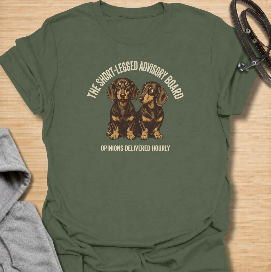 For dachshund owners who never have to wonder what their dogs think — because the opinions arrive all day long. This funny dachshund T-shirt features “The Short-Legged Advisory Board” with the line “Opinions Delivered Hourly” and two wonderfully serious doxies. Perfect for anyone who shares their home with small dogs, big personalities and absolutely no shortage of commentary. A fun vintage-style dachshund tee for sausage dog lovers who know they are never really in charge.