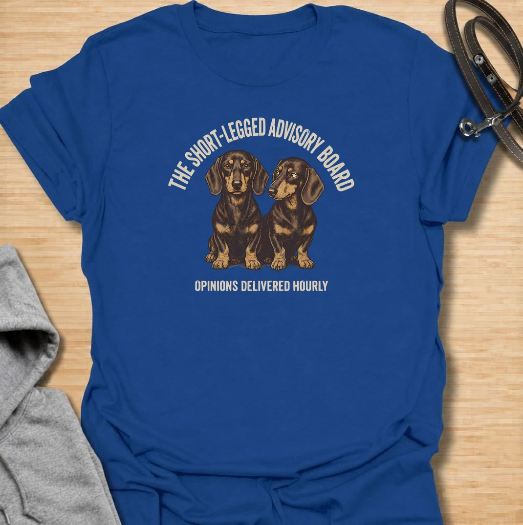 For dachshund owners who never have to wonder what their dogs think — because the opinions arrive all day long. This funny dachshund T-shirt features “The Short-Legged Advisory Board” with the line “Opinions Delivered Hourly” and two wonderfully serious doxies. Perfect for anyone who shares their home with small dogs, big personalities and absolutely no shortage of commentary. A fun vintage-style dachshund tee for sausage dog lovers who know they are never really in charge.