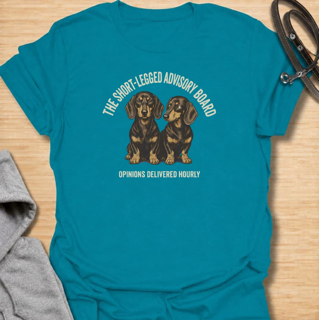 For dachshund owners who never have to wonder what their dogs think — because the opinions arrive all day long. This funny dachshund T-shirt features “The Short-Legged Advisory Board” with the line “Opinions Delivered Hourly” and two wonderfully serious doxies. Perfect for anyone who shares their home with small dogs, big personalities and absolutely no shortage of commentary. A fun vintage-style dachshund tee for sausage dog lovers who know they are never really in charge.