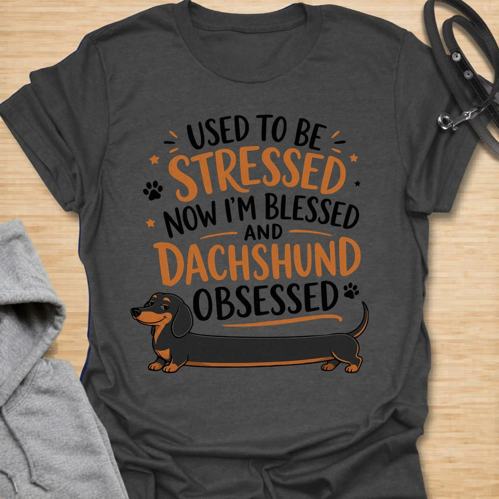 This Used To Be Stressed Now I’m Blessed And Dachshund Obsessed t-shirt is made for dachshund lovers who know life got a whole lot better with a sausage dog in it. Featuring playful stacked typography, a long dachshund illustration, and a fun feel-good message, this design has a cheerful and relatable dog-lover vibe. Perfect for dachshund moms, dachshund dads, wiener dog fans, doxie owners, and anyone who proudly admits they are completely dachshund obsessed.