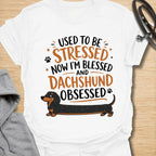 This Used To Be Stressed Now I’m Blessed And Dachshund Obsessed t-shirt is made for dachshund lovers who know life got a whole lot better with a sausage dog in it. Featuring playful stacked typography, a long dachshund illustration, and a fun feel-good message, this design has a cheerful and relatable dog-lover vibe. Perfect for dachshund moms, dachshund dads, wiener dog fans, doxie owners, and anyone who proudly admits they are completely dachshund obsessed.