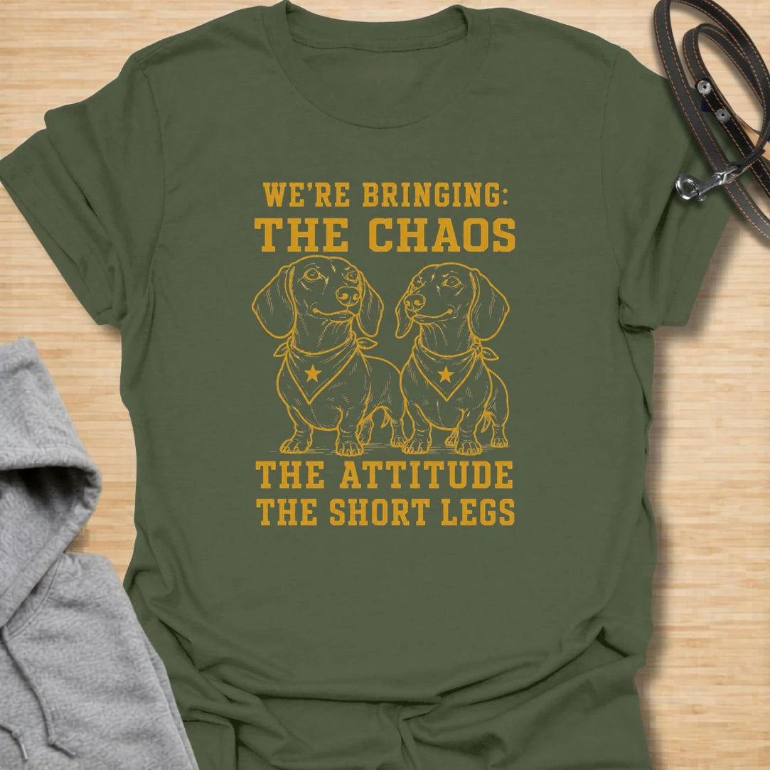 This We’re Bringing The Chaos t-shirt is made for dachshund lovers who know two little long dogs can bring double the attitude and double the noise. Featuring two dachshunds in bandanas with bold stacked lettering, this design has a funny dog-parent feel for anyone who lives with tiny-legged trouble. Perfect for dachshund moms, dachshund dads, multi-dog homes, wiener dog fans, and rescue dog lovers.