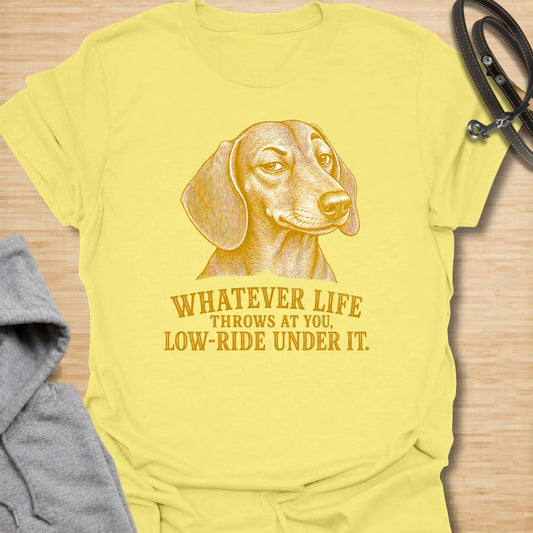 This Whatever Life Throws At You Low-Ride Under It t-shirt is made for dachshund lovers who know short legs can be a whole advantage. Featuring a vintage-style dachshund portrait and bold lettering, this design has a funny, resilient dog-parent feel. Perfect for dachshund moms, dachshund dads, wiener dog fans, rescue dog lovers, and anyone who loves a low-riding dog with a big personality.