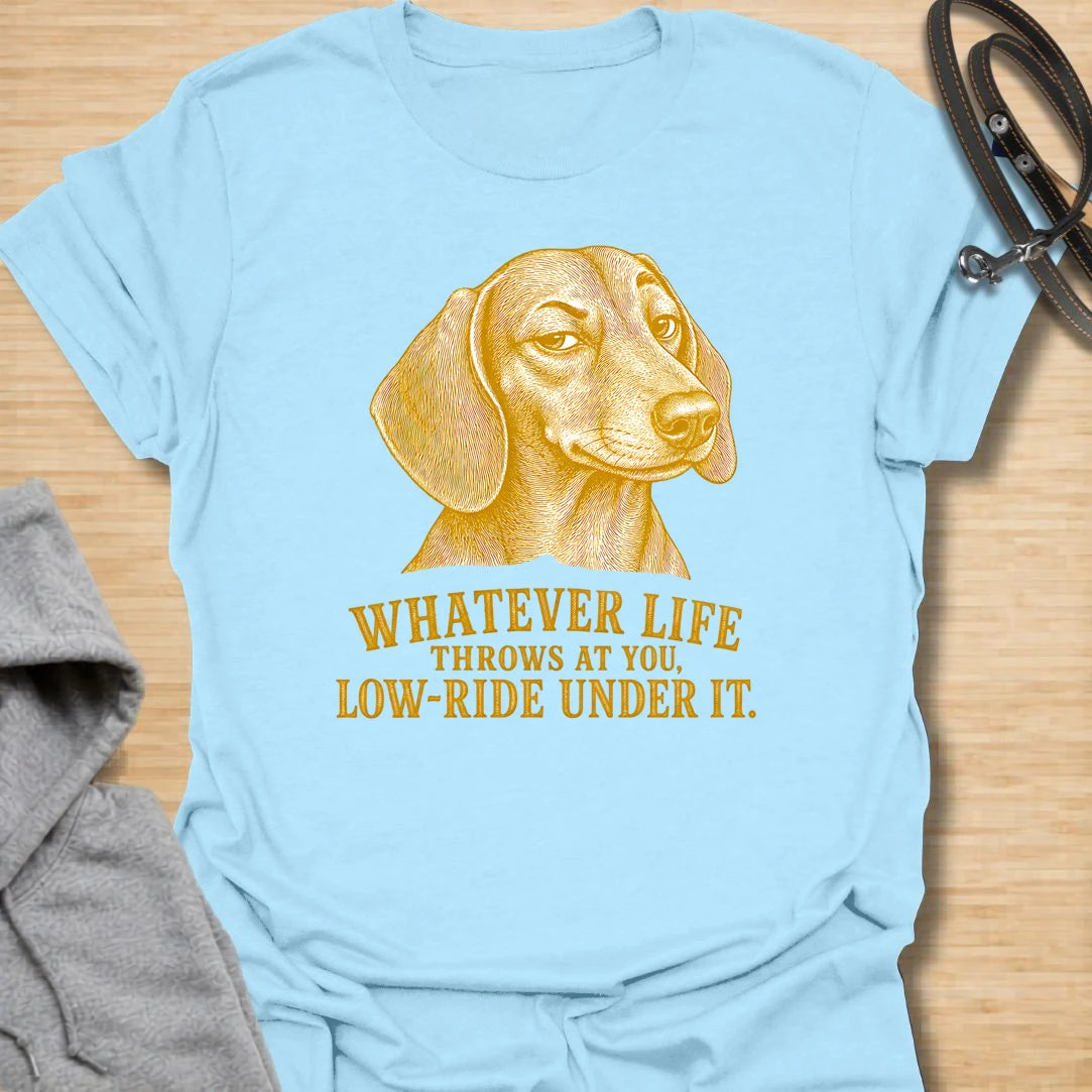 This Whatever Life Throws At You Low-Ride Under It t-shirt is made for dachshund lovers who know short legs can be a whole advantage. Featuring a vintage-style dachshund portrait and bold lettering, this design has a funny, resilient dog-parent feel. Perfect for dachshund moms, dachshund dads, wiener dog fans, rescue dog lovers, and anyone who loves a low-riding dog with a big personality.