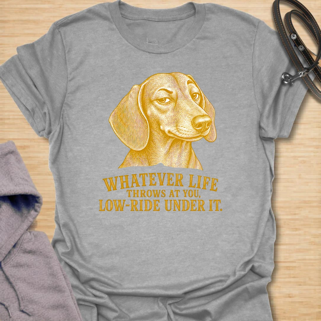 This Whatever Life Throws At You Low-Ride Under It t-shirt is made for dachshund lovers who know short legs can be a whole advantage. Featuring a vintage-style dachshund portrait and bold lettering, this design has a funny, resilient dog-parent feel. Perfect for dachshund moms, dachshund dads, wiener dog fans, rescue dog lovers, and anyone who loves a low-riding dog with a big personality.
