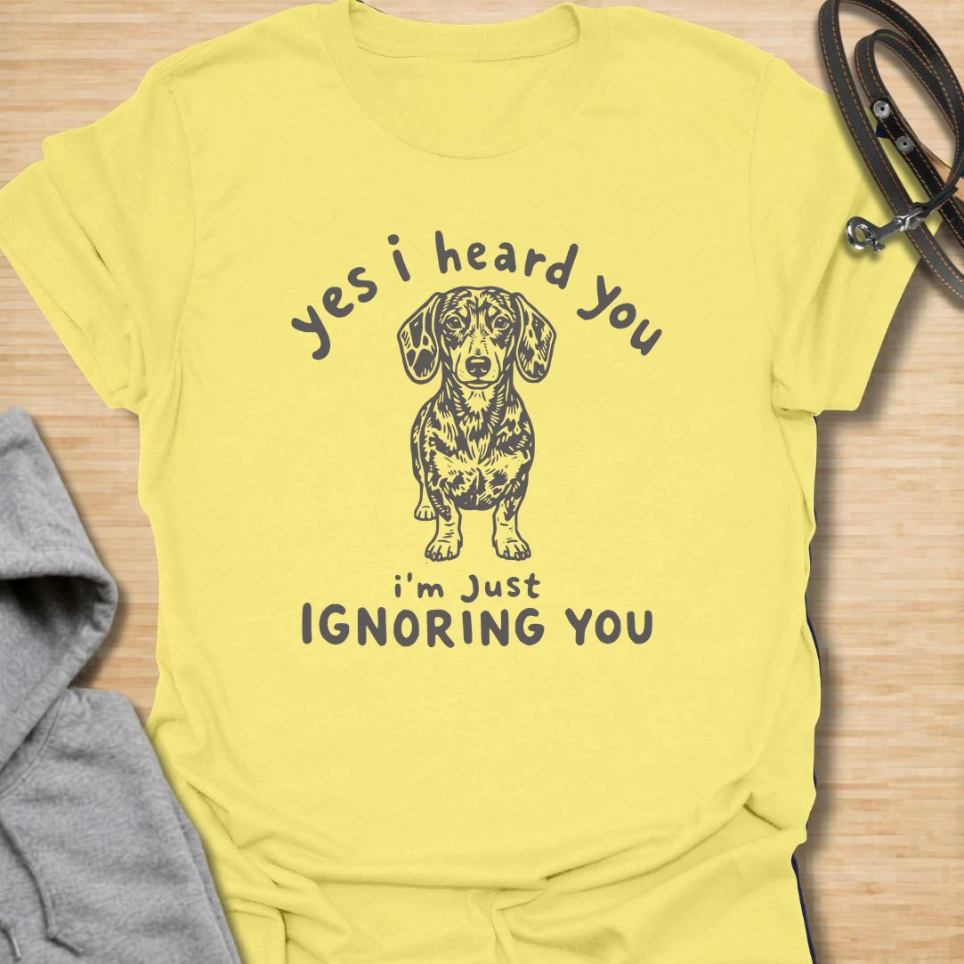 Ignoring You t-shirt for dachshund owners who know their dog hears everything but chooses selective listening. This funny design features a serious doxie with the phrase “Yes I Heard You I’m Just Ignoring You.” Perfect for sausage dog fans, doxie moms, and anyone living with a stubborn little dog.