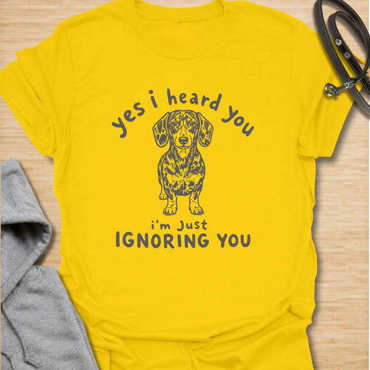 Ignoring You t-shirt for dachshund owners who know their dog hears everything but chooses selective listening. This funny design features a serious doxie with the phrase “Yes I Heard You I’m Just Ignoring You.” Perfect for sausage dog fans, doxie moms, and anyone living with a stubborn little dog.
