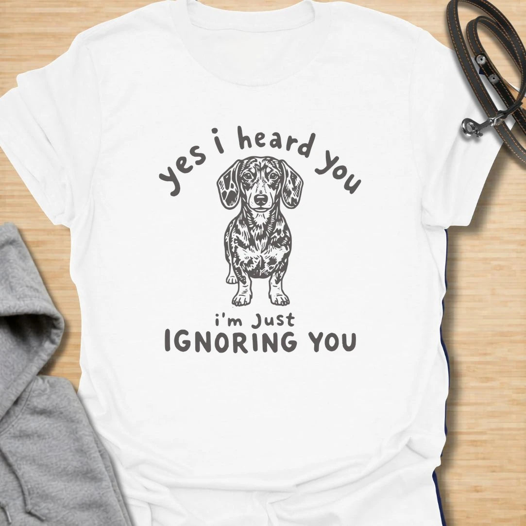Ignoring You t-shirt for dachshund owners who know their dog hears everything but chooses selective listening. This funny design features a serious doxie with the phrase “Yes I Heard You I’m Just Ignoring You.” Perfect for sausage dog fans, doxie moms, and anyone living with a stubborn little dog.