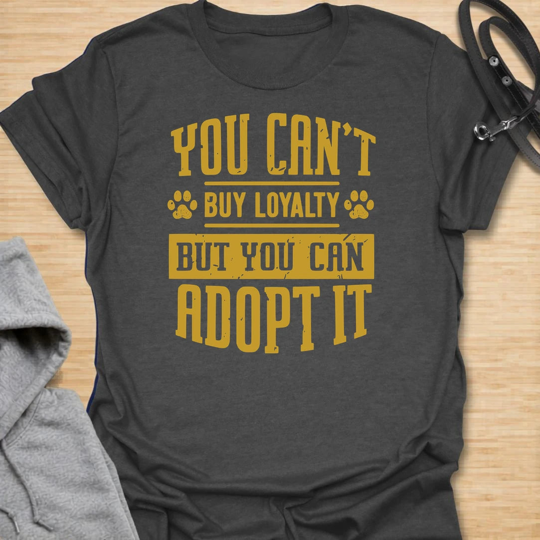 This You Can’t Buy Loyalty But You Can Adopt It t-shirt is made for rescue dog lovers who believe the best kind of love comes from giving a dog a second chance. Featuring bold distressed typography with paw print details, this design has a simple, meaningful rescue-dog message that is easy to wear every day. Perfect for rescue dog moms, rescue dog dads, shelter dog adopters, foster families, animal lovers, and anyone who proudly supports adoption. Charcoal