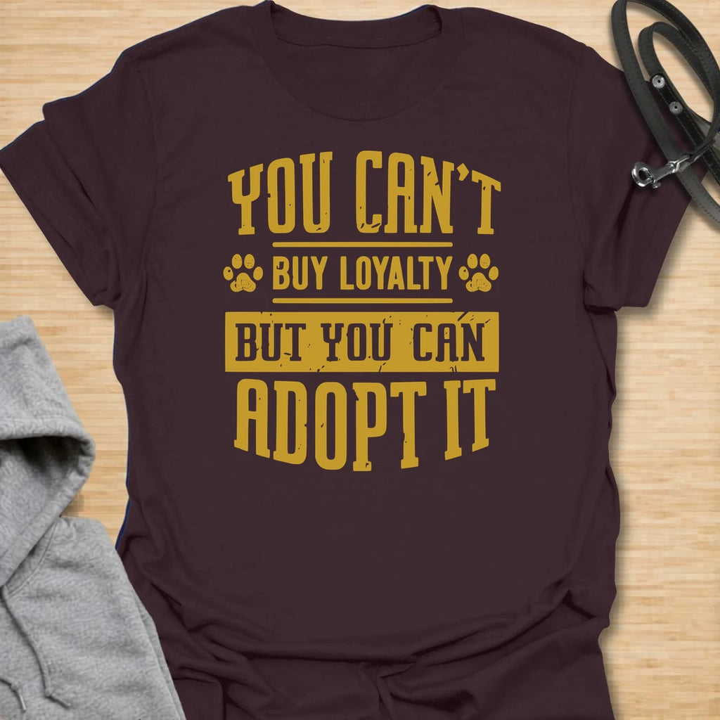 This You Can’t Buy Loyalty But You Can Adopt It t-shirt is made for rescue dog lovers who believe the best kind of love comes from giving a dog a second chance. Featuring bold distressed typography with paw print details, this design has a simple, meaningful rescue-dog message that is easy to wear every day. Perfect for rescue dog moms, rescue dog dads, shelter dog adopters, foster families, animal lovers, and anyone who proudly supports adoption. Dark Chocolate